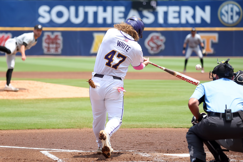 LSU Tigers infielder Tommy White swings and gets a base hit