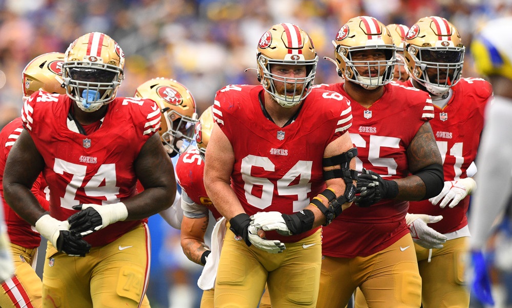 The 49ers offensive line comes out of the huddle and approaches the line of scrimmage.